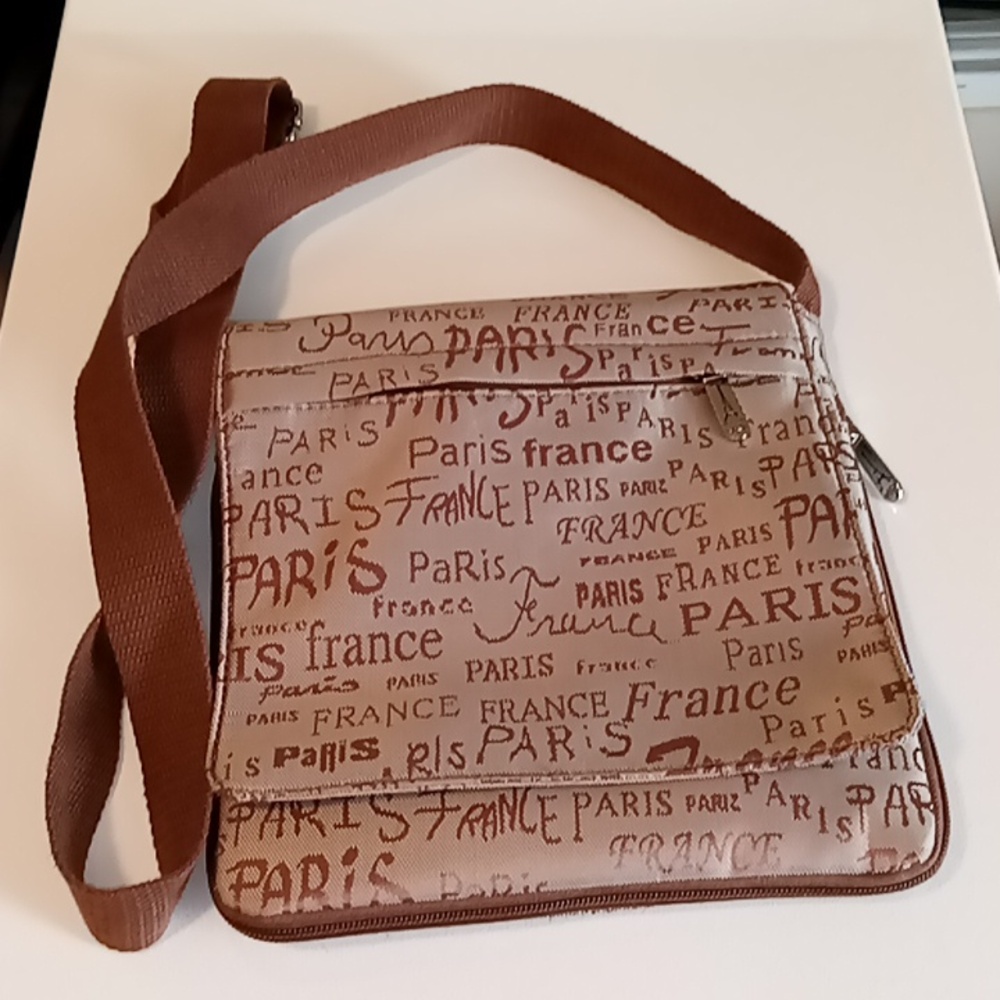 Paris France brown crossbody bag with expandable interior.